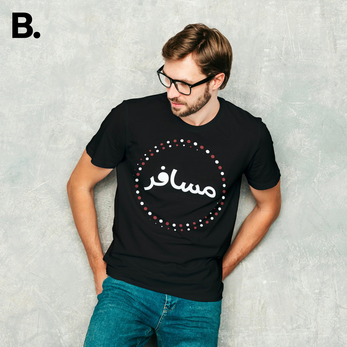 Model wearing the black Musafir calligraphy tee with white Urdu lettering and red and white circular details