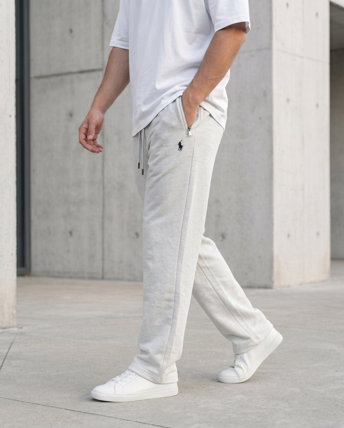 Side view of a model walking in Grey cotton terry trousers