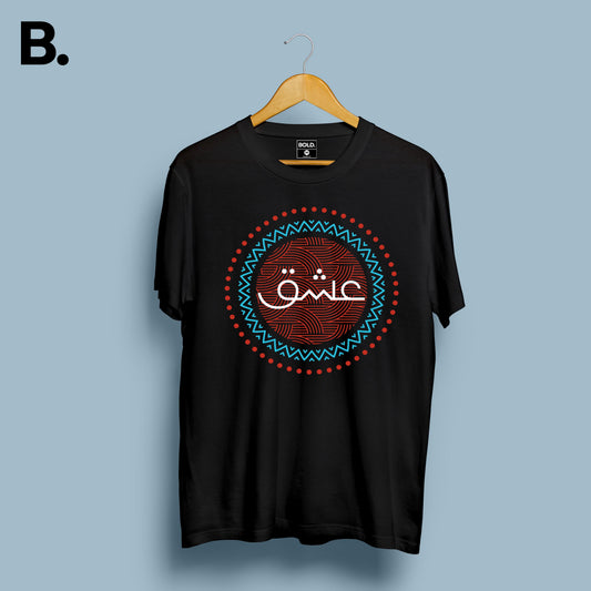 Black Ishq calligraphy tee on a hanger with white Urdu lettering and a red and turquoise circular design