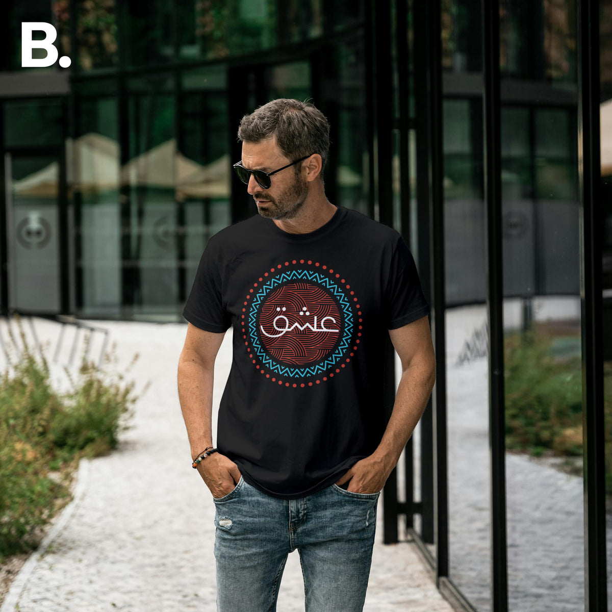 Outdoor front view of a model wearing the black Ishq calligraphy tee