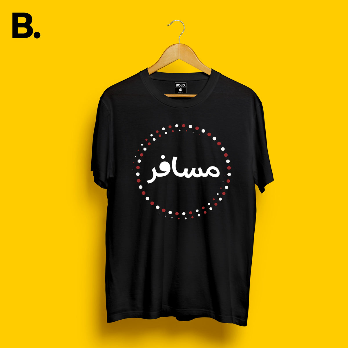 Black Musafir calligraphy tee on a hanger with white Urdu lettering and a red and white dotted circle
