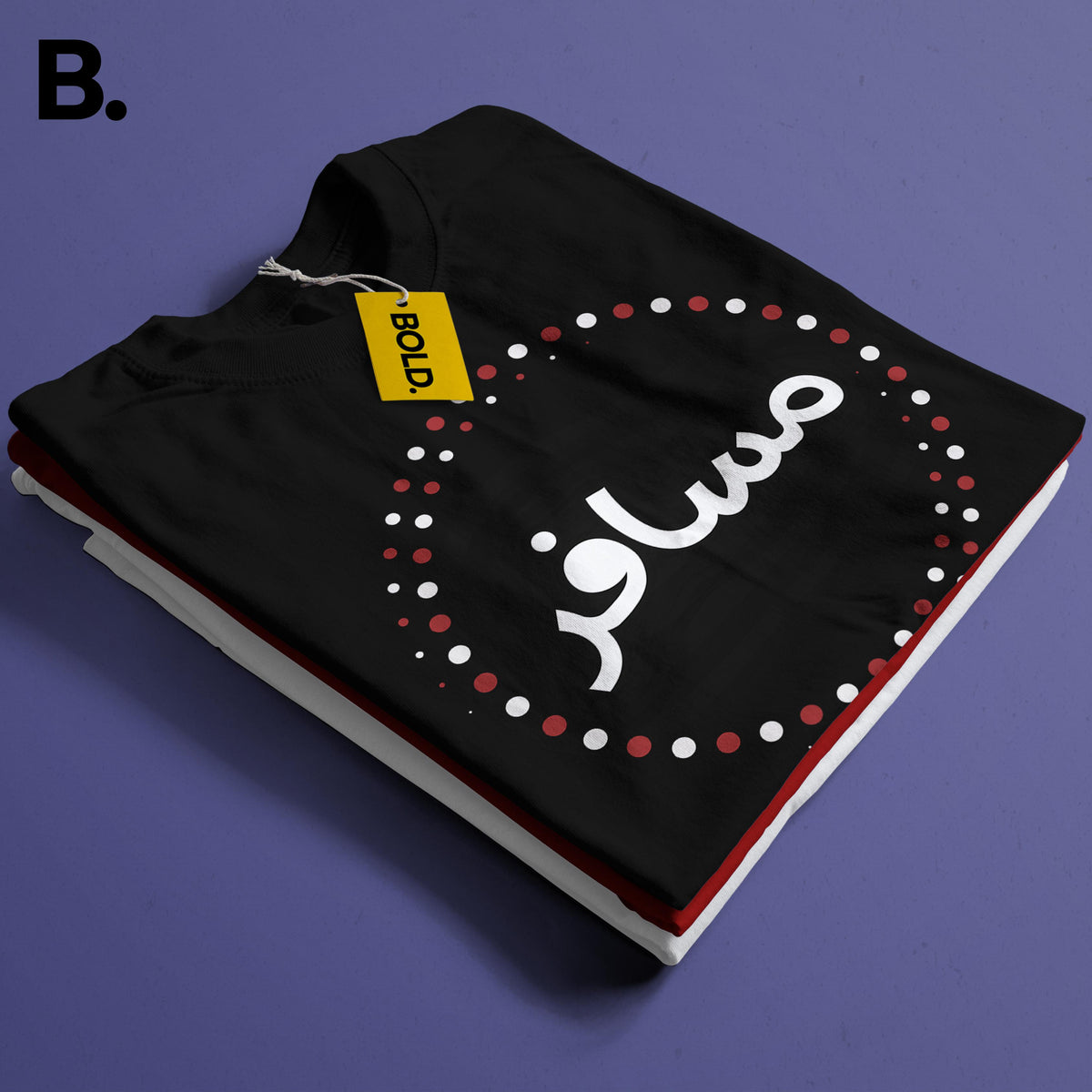 Close-up of the folded black Musafir tee showing white Urdu lettering and a red and white dotted circle