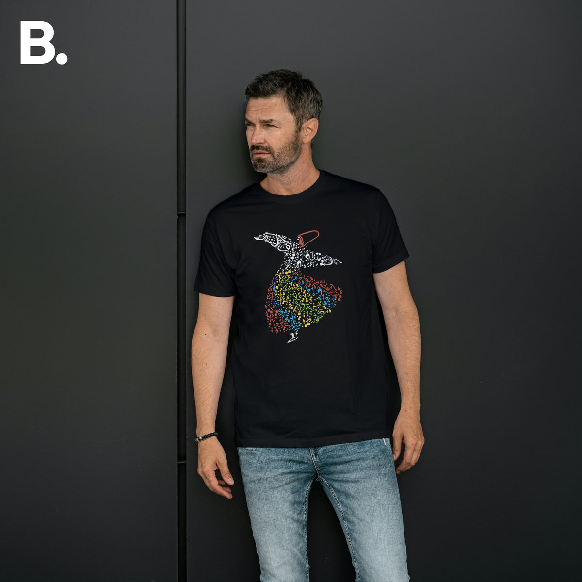 Front view of a model wearing the black Sufi calligraphy tee
